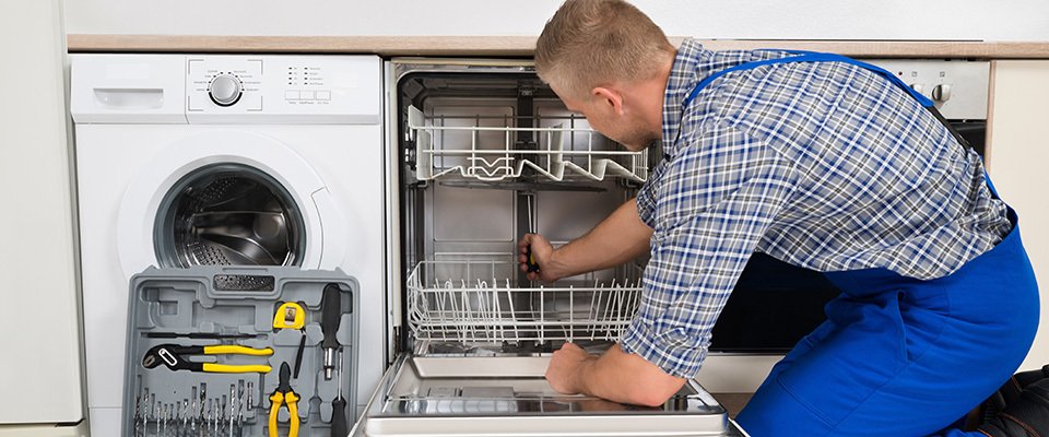 Service technician repairing dishwasher